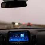 Interior view of a car dashboard on an open road during the day. Perfect for travel-themed projects.