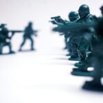 Green toy soldiers in formation on white background