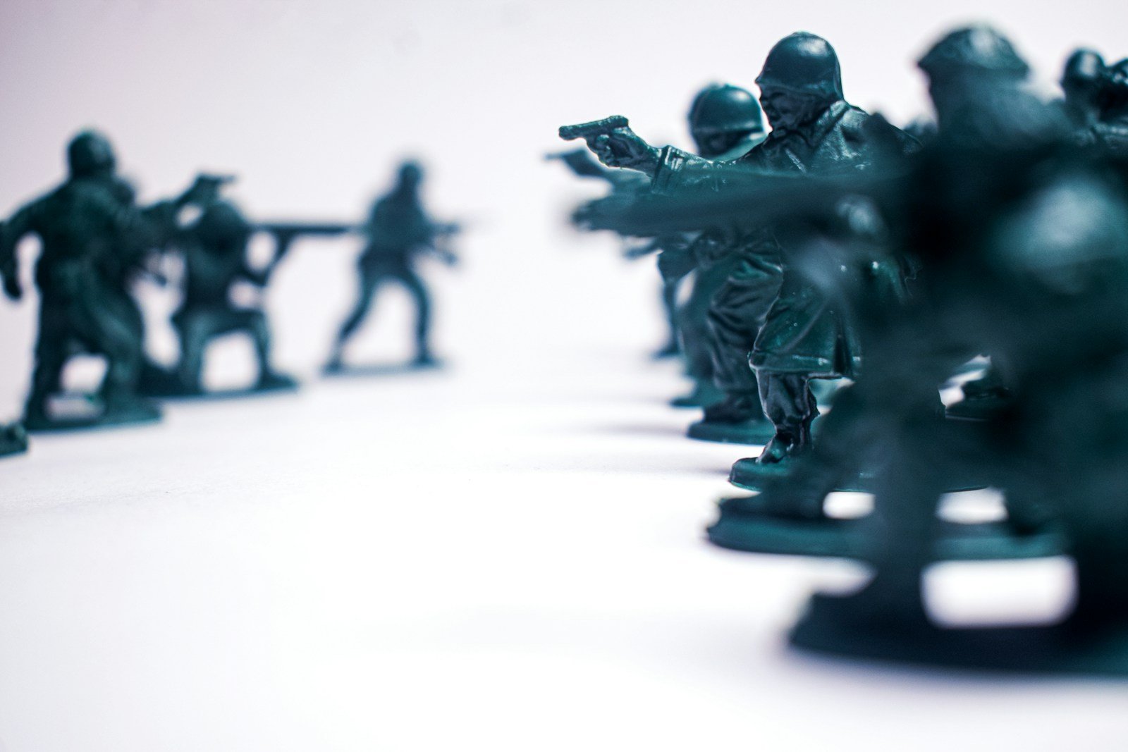 Green toy soldiers in formation on white background