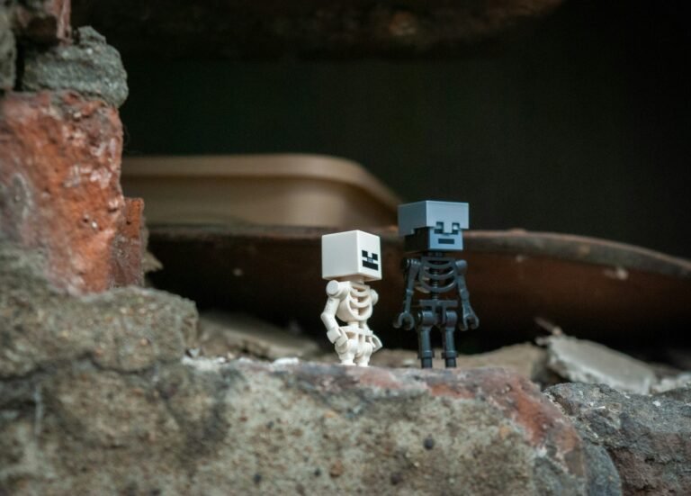 Two skeleton figures stand on rubble